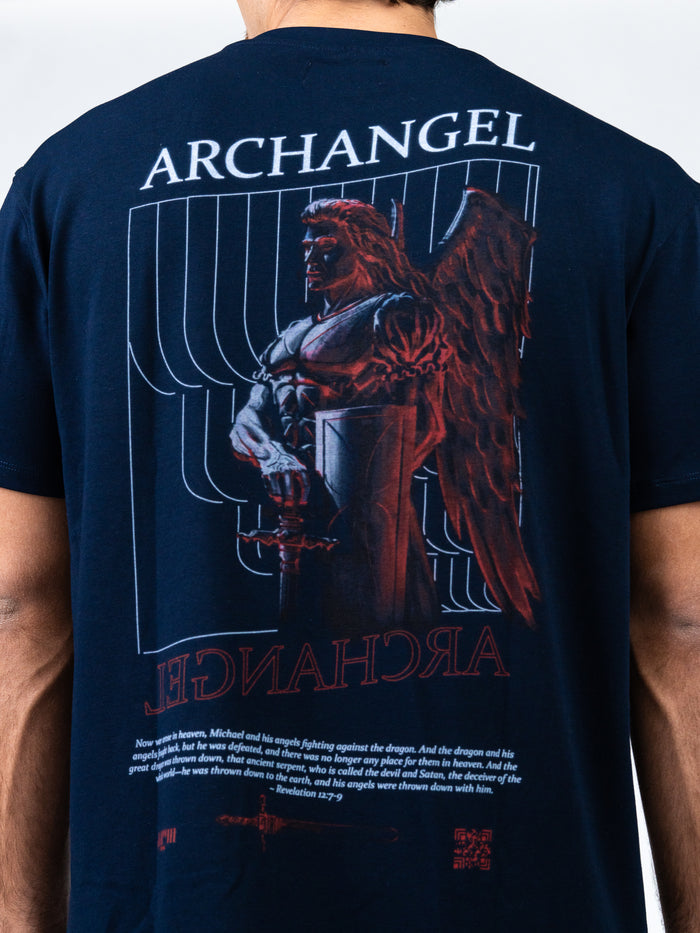 Back view of a person wearing the Archangel Michael Premium Oversized Tee featuring a detailed graphic of Archangel Michael with wings, armor, and sword, along with scriptural text and design elements.