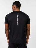 Person wearing a black t-shirt with 'Carry Your Cross' text on the back against a white background