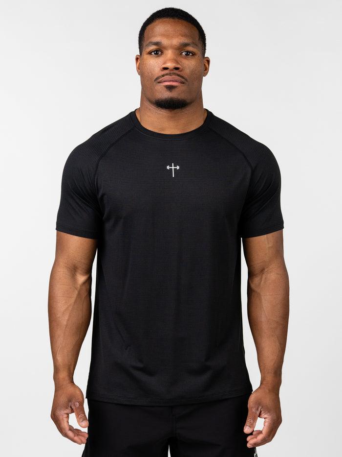 Man wearing a black t-shirt with a logo on a white background