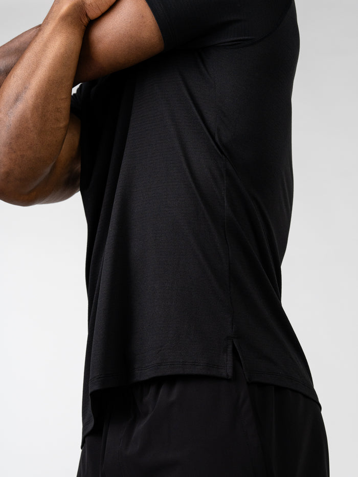 Close-up side view of a person wearing a black Carry Your Cross Premium Tee, showing the fabric texture and fit on the upper body, highlighting its use as Christian fitness apparel.