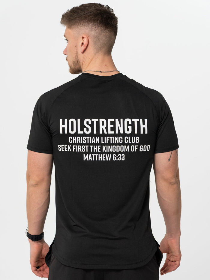 Man wearing a black t-shirt with 'Holstrength Christian Lifting Club' text on the back.