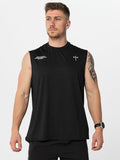 Man wearing a black sleeveless athletic shirt and shorts on a white background