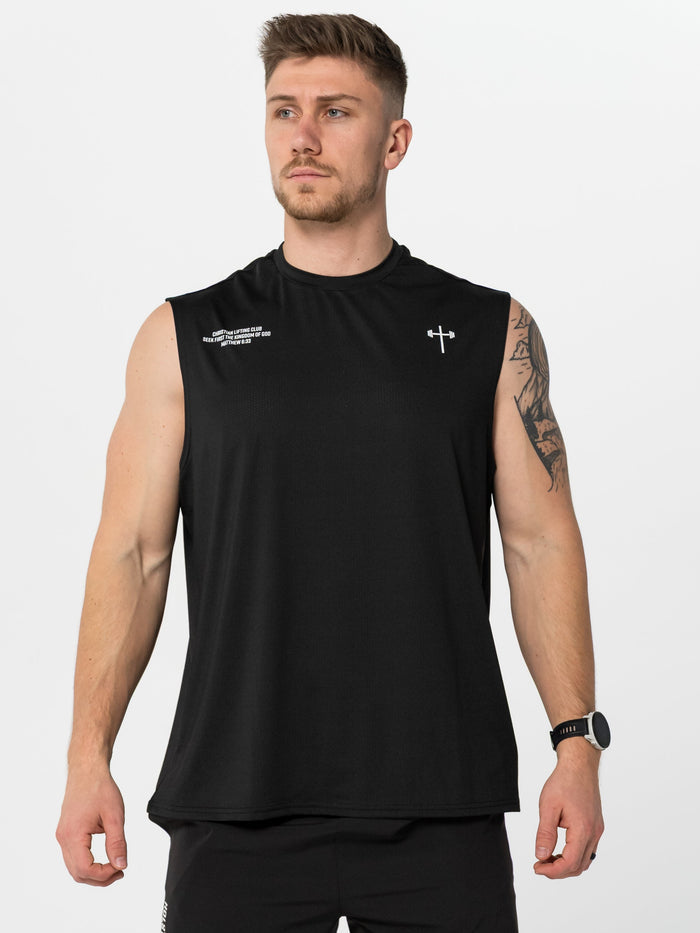 Man wearing a black sleeveless athletic shirt and shorts on a white background