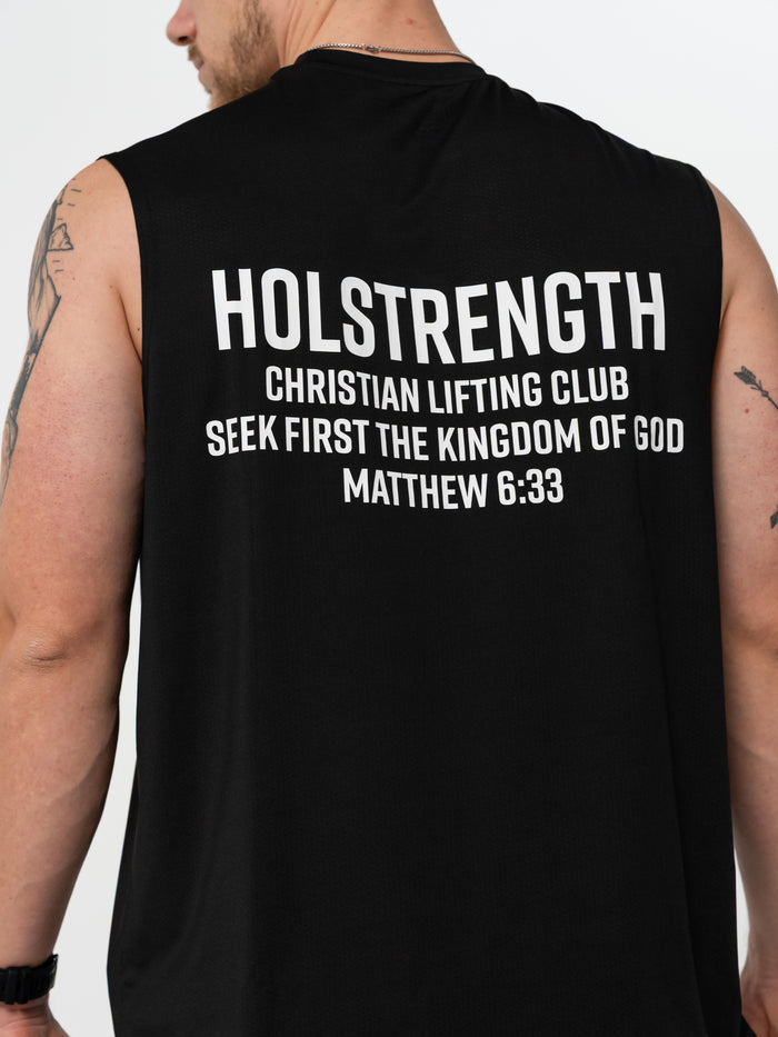 Black sleeveless shirt with 'HOLSTRENGTH Christian Lifting Club' text on the back, on a person against a gray background.
