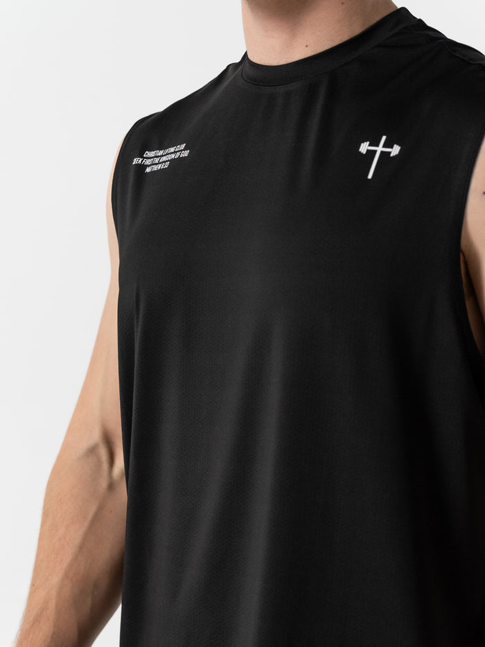 Close-up of a black Christian Lifting Club Premium Oversized Tank featuring a small white cross with barbell logo on the chest, made from lightweight performance fabric for faith-based fitness.