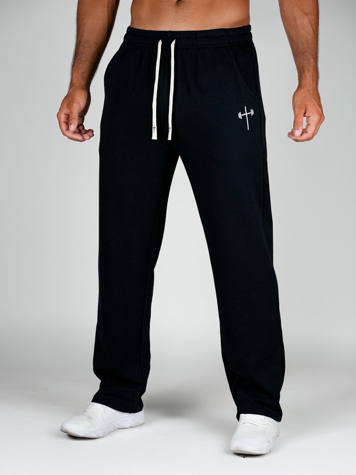 Black sweatpants with a white logo on a gray background