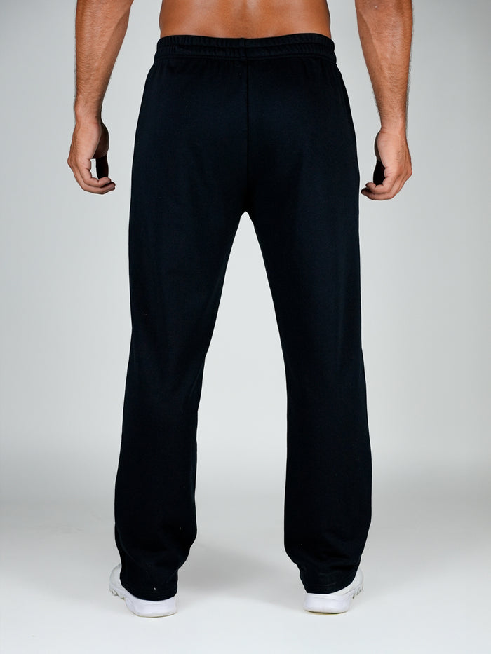Black sweatpants worn by a person on a white background