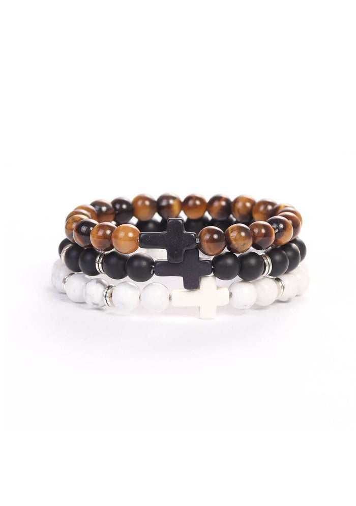 Stack of three beaded bracelets featuring polished tiger eye, matte black, and white marbled beads, each with a cross-shaped centerpiece, representing faith and strength in the Cross Wristband Pack.