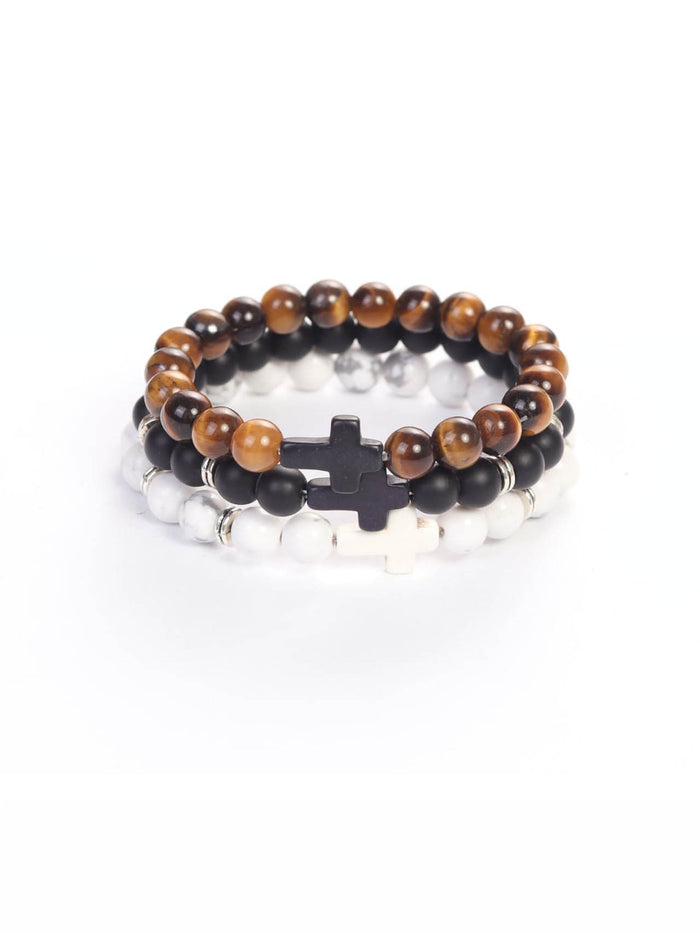 Cross Wristband Pack featuring three beaded bracelets with cross-shaped accents in brown tiger eye, black matte, and white marble styles for faith-based fitness wear.