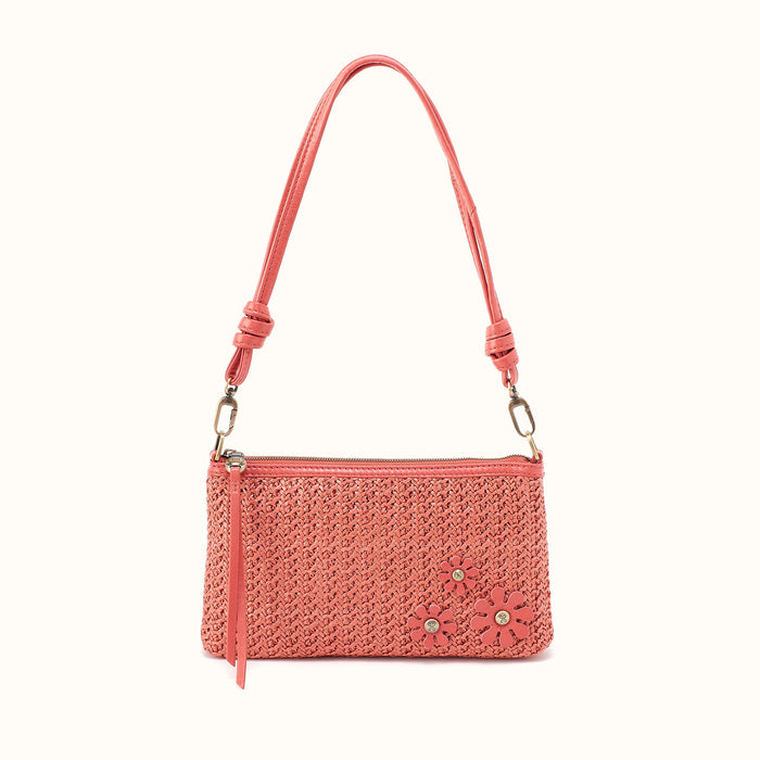 Pink woven handbag with a floral design on a white background