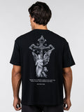Person wearing a black t-shirt with an angel and cross design on the back, against a white background.