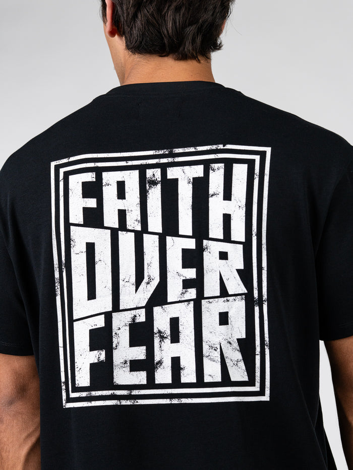 Rear view of a black Faith Over Fear Premium Oversized Tee featuring a bold white distressed graphic text design, ideal Christian fitness apparel for faith based workout clothes.