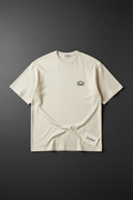 Lotus Minimal Embroidery Tee — Cream oversized tee with lotus chest embroidery by Varidon