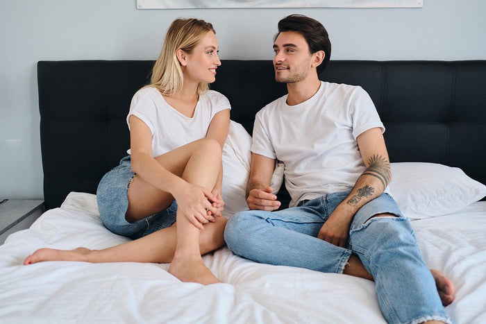 lifestyle image of a man and women wearing white t-shirts from the perfect tshirt co