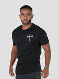 Man wearing a black t-shirt with a white logo, front view