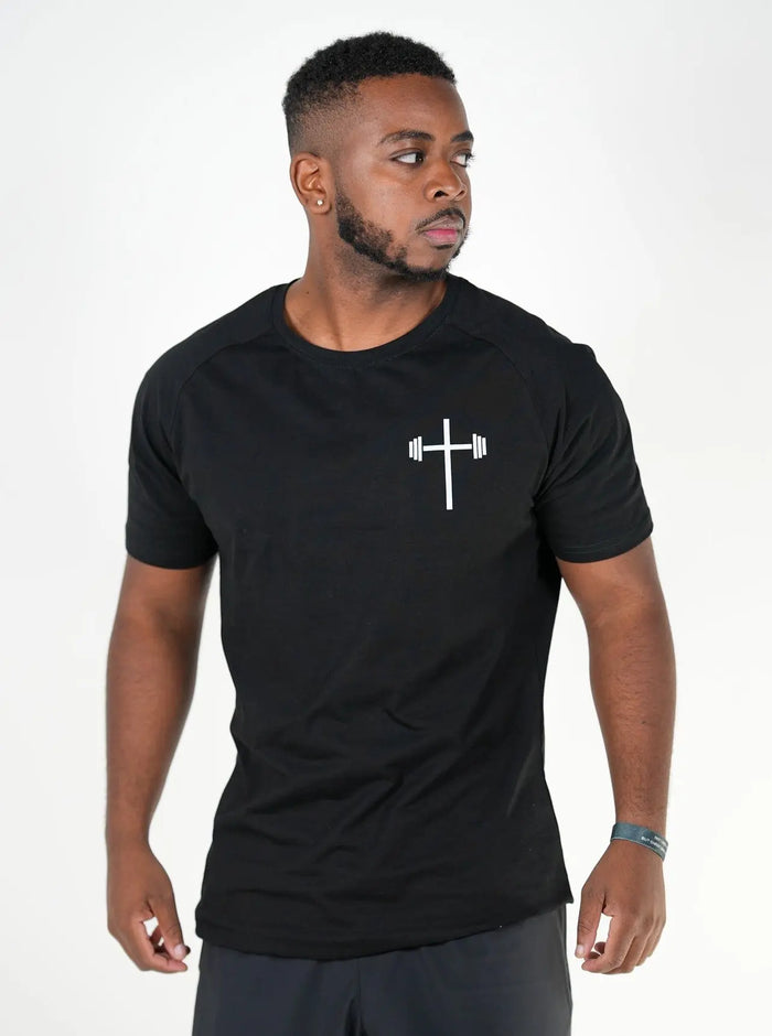 Man wearing a black t-shirt with a white logo, front view