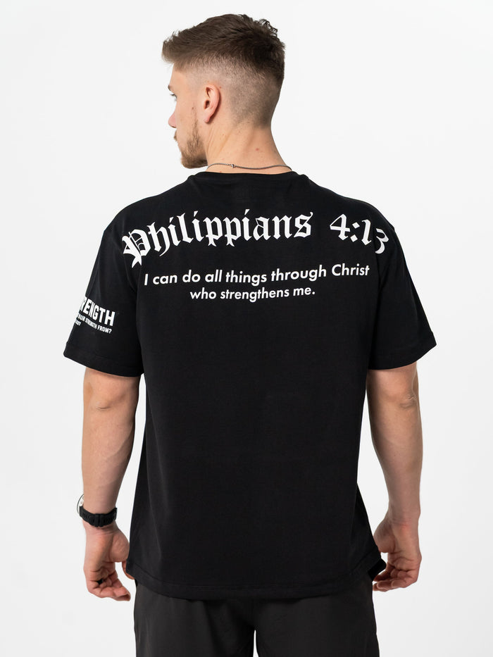 Person wearing a black t-shirt with 'Philippians 4:13' text on the back.