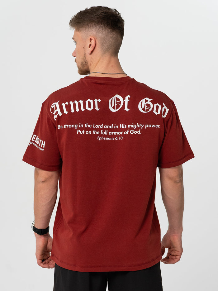 Man wearing a maroon 'Armor of God' t-shirt with text on the back.