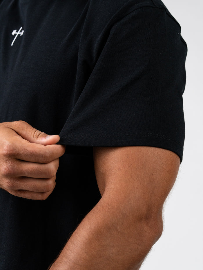 Close-up of a person wearing the Seek the Lord Premium Oversized Tee, showcasing the structured heavyweight fabric and relaxed fit around the sleeve, emphasizing Christian fitness apparel quality.
