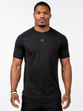 Male model wearing a black Signature Tee featuring a subtle cross with a barbell design on the chest, designed for performance with breathable, stretch fabric suitable for Christian fitness apparel.