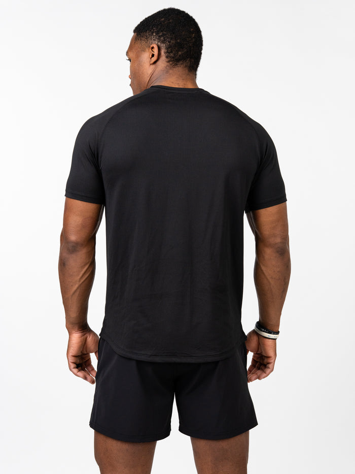 Man wearing a black Signature Tee viewed from the back, showcasing a breathable, stretchy fabric designed for intense training and durability in Christian gym clothing.