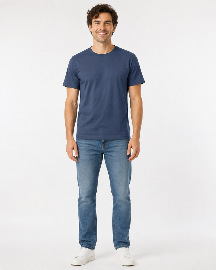 men's indigo blue t-shirt and blue jeans and whtite sneakers on a white background