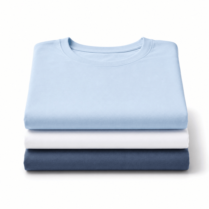 Three neatly folded crewneck t-shirts stacked vertically on a white background, shown in light blue, white, and indigo blue.