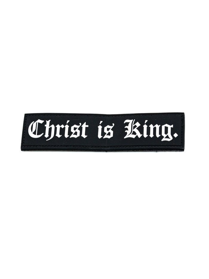 Black Velcro Patch with white text reading "Christ is King" in a classic Gothic font, designed for Christian fitness apparel or activewear.