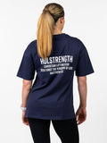 Person wearing a navy blue t-shirt with text on the back, standing against a white background