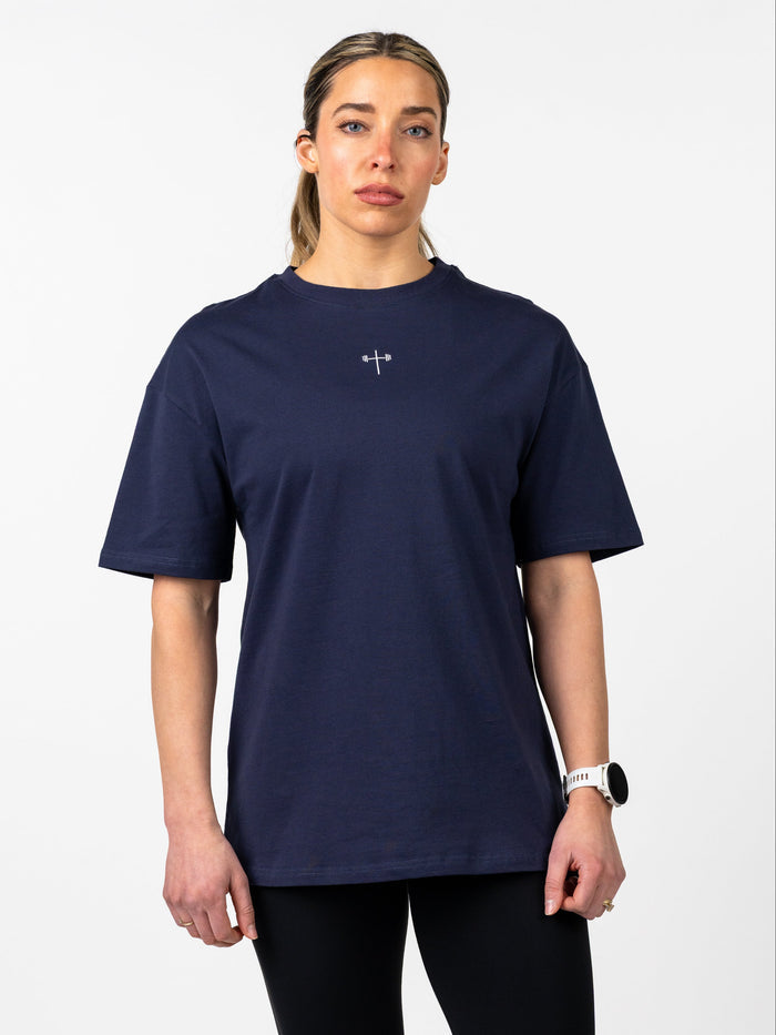 Person wearing a navy blue t-shirt with a logo on a white background
